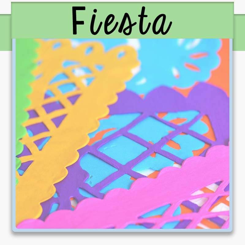 macro shot of colorful fiesta banners in orange, purple, blue and pink with text overlay fiesta