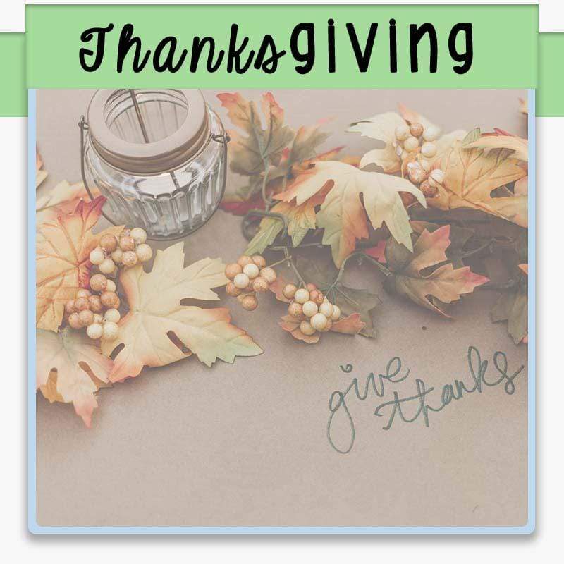Thanksgiving placemat of brown paper with hand lettering give thanks surrounded by fall leaves a candle and text overlay Thanksgiving